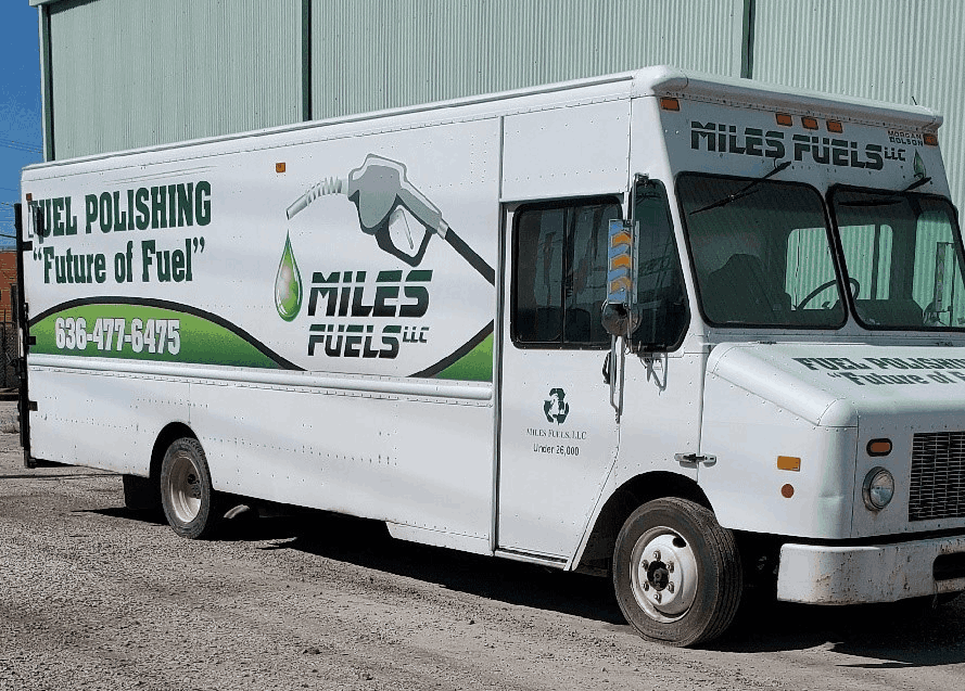 A white truck with the words " miles fuels " on it.